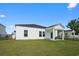 Well-kept backyard with green grass and a covered patio for outdoor enjoyment at 109 River Vista Way, Myrtle Beach, SC 29588