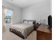 Well-lit bedroom with a window featuring blinds, a bed, and dresser at 109 River Vista Way, Myrtle Beach, SC 29588