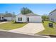 Charming one-story home with a white exterior, a two-car garage, and a neatly manicured lawn at 109 River Vista Way, Myrtle Beach, SC 29588