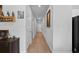 The hallway has neutral walls and wood-look flooring with access to bedrooms and living areas at 109 River Vista Way, Myrtle Beach, SC 29588
