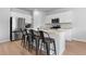 Open-concept kitchen featuring a granite island with bar stools and modern stainless steel appliances at 109 River Vista Way, Myrtle Beach, SC 29588