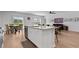 Open kitchen layout flowing into dining area and living room, featuring a central island with barstool seating at 109 River Vista Way, Myrtle Beach, SC 29588