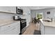 Bright kitchen with modern appliances, granite counters, and an adjacent dining area with backyard views at 109 River Vista Way, Myrtle Beach, SC 29588