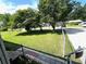 View of a well-manicured front yard with mature trees, a fenced boundary, and a charming home at 1110 Scott Dr., Myrtle Beach, SC 29577