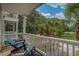 Balcony featuring chairs and a view of palm trees, greenery, and a clear sky at 118A 6Th Ave. N, Surfside Beach, SC 29575