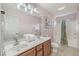 Bright bathroom featuring a double sink vanity and a tub with vibrant floral shower curtain at 118A 6Th Ave. N, Surfside Beach, SC 29575
