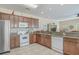Well-lit kitchen boasts wood cabinets, granite countertops, and modern white appliances at 118A 6Th Ave. N, Surfside Beach, SC 29575