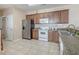 Cozy kitchen features granite countertops, wood cabinets and stainless steel refrigerator at 118A 6Th Ave. N, Surfside Beach, SC 29575
