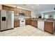 Kitchen with stainless steel appliances, wooden cabinets, and tiled flooring at 118A 6Th Ave. N, Surfside Beach, SC 29575