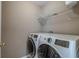 Laundry room with front load washer and dryer, overhead storage, and neutral colored walls at 118A 6Th Ave. N, Surfside Beach, SC 29575
