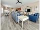 This living area boasts a sleek ceiling fan, stylish furniture, and elegant hardwood floors throughout at 118A 6Th Ave. N, Surfside Beach, SC 29575
