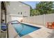 Private pool area with lounge chairs and white privacy fence, perfect for relaxing outdoors at 118A 6Th Ave. N, Surfside Beach, SC 29575