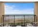 Balcony with seating, overlooking the serene beach and ocean waves, with a view of the pier in the distance at 1200 N Ocean Blvd. # 710, Myrtle Beach, SC 29577