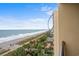 Balcony with an expansive view of the beach, ocean, and iconic SkyWheel in the distance, near the exterior wall at 1200 N Ocean Blvd. # 710, Myrtle Beach, SC 29577
