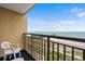 Balcony with seating overlooks the calming ocean, beach, and a pier in the distance, for a relaxing escape at 1200 N Ocean Blvd. # 710, Myrtle Beach, SC 29577