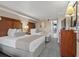 This inviting bedroom features two plush beds, a dresser with a TV, and an open view of a private balcony at 1200 N Ocean Blvd. # 710, Myrtle Beach, SC 29577