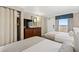 Cozy bedroom showcasing two beds, a dresser with lamps and TV, and a view to the building's exterior at 1200 N Ocean Blvd. # 710, Myrtle Beach, SC 29577