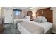 This lovely bedroom features two plush beds, a dresser with a TV, and an open view of the building's exterior at 1200 N Ocean Blvd. # 710, Myrtle Beach, SC 29577