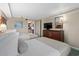 Bright bedroom featuring two comfortable beds, dresser with TV, and a glimpse into the adjacent kitchen area at 1200 N Ocean Blvd. # 710, Myrtle Beach, SC 29577