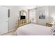 Bright bedroom featuring a detailed wooden dresser, soft pink accents, and ample natural light at 1204 River Oak Dr. # 25-A, Myrtle Beach, SC 29579