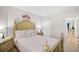 Bright bedroom featuring a detailed wooden bed frame, soft pink bedding, and a closet at 1204 River Oak Dr. # 25-A, Myrtle Beach, SC 29579