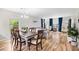 Open dining room with seating for six, hardwood floors, and an adjacent living space at 1204 River Oak Dr. # 25-A, Myrtle Beach, SC 29579