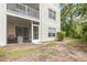 Exterior view of back of condo building with an outdoor patio that includes an outdoor dining set at 1204 River Oak Dr. # 25-A, Myrtle Beach, SC 29579