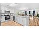 Modern kitchen featuring white cabinetry, stainless steel appliances, and granite counters open to the dining and living area at 1204 River Oak Dr. # 25-A, Myrtle Beach, SC 29579