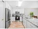 Modern kitchen featuring white cabinetry, stainless steel appliances, granite counters, and hardwood floors for a sleek look at 1204 River Oak Dr. # 25-A, Myrtle Beach, SC 29579