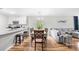 Open-concept living space with a large table, hardwood floors, and a comfortable gray sofa for modern living at 1204 River Oak Dr. # 25-A, Myrtle Beach, SC 29579