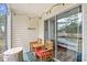 Charming screened porch with outdoor furniture and string lights, perfect for relaxation at 1204 River Oak Dr. # 25-A, Myrtle Beach, SC 29579