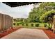 Enjoy outdoor living in this backyard with lawn, shade trees, and a defined border of small shrubs at 130 Scotch Broom Dr. # H-103, Little River, SC 29566