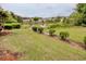 This home features a backyard with pond view and manicured shrub borders at 130 Scotch Broom Dr. # H-103, Little River, SC 29566