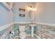 Stylish powder room with rustic wood paneling, pedestal sink, unique lighting fixture, and light blue walls at 130 Scotch Broom Dr. # H-103, Little River, SC 29566