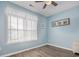 Inviting bedroom with a bright window, ceiling fan, neutral walls and wood-look flooring at 130 Scotch Broom Dr. # H-103, Little River, SC 29566