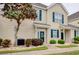 Inviting townhouse with neutral siding, dark green shutters, decorative landscaping and a lush tree at 130 Scotch Broom Dr. # H-103, Little River, SC 29566