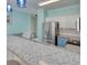 Spacious kitchen with a long breakfast bar, granite countertops, stainless steel appliances, and two-tone cabinetry at 130 Scotch Broom Dr. # H-103, Little River, SC 29566