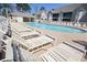 Community pool featuring numerous lounge chairs, cabana and well-maintained grounds on a clear day at 130 Scotch Broom Dr. # H-103, Little River, SC 29566