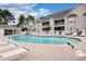 Community pool with several lounge chairs, and manicured grounds in front of multi-Gathering homes at 130 Scotch Broom Dr. # H-103, Little River, SC 29566