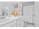 Tastefully designed bathroom with white cabinetry, marble flooring, and decorative woven baskets at 1301 Bay View Ct., North Myrtle Beach, SC 29582