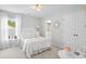 Bright bedroom with a comfortable bed, beautiful wallpaper, and access to a charming ensuite bathroom at 1301 Bay View Ct., North Myrtle Beach, SC 29582
