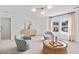 Bright living room featuring a wicker coffee table, comfortable chairs, and neutral decor at 1301 Bay View Ct., North Myrtle Beach, SC 29582