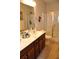 Well-lit bathroom with double sink vanity and glass-enclosed shower, blending functionality and style at 1308 Riverport Dr., Conway, SC 29526