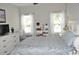 Light-filled bedroom with calming colors, featuring a plush bed, dresser, and picturesque windows at 1308 Riverport Dr., Conway, SC 29526