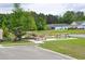 Community area with picnic tables near pond, surrounded by lush landscaping at 1308 Riverport Dr., Conway, SC 29526