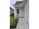 Inviting front entry with a cozy chair and well-maintained landscaping at 1308 Riverport Dr., Conway, SC 29526