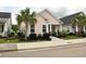 Inviting home exterior with a well-kept lawn, featuring a palm tree and a quaint front porch at 1308 Riverport Dr., Conway, SC 29526