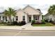 A beautiful single-story house with manicured lawn, palm tree, and walkway to the front porch at 1308 Riverport Dr., Conway, SC 29526