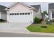 Home exterior features a two-car garage and mature landscaping at 1308 Riverport Dr., Conway, SC 29526