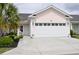 Home exterior showcases a two-car garage and well-manicured landscaping at 1308 Riverport Dr., Conway, SC 29526